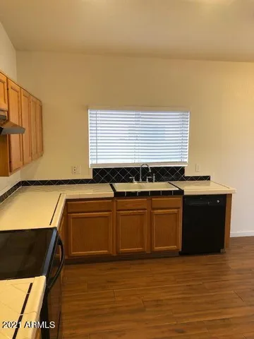a kitchen with stainless steel appliances granite countertop a sink and cabinets