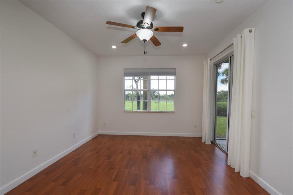 8297 Northwest 128th Lane, Unit 20C Parkland, FL 33076 - Photo 12 of 42 wooden floor in an empty room with a window