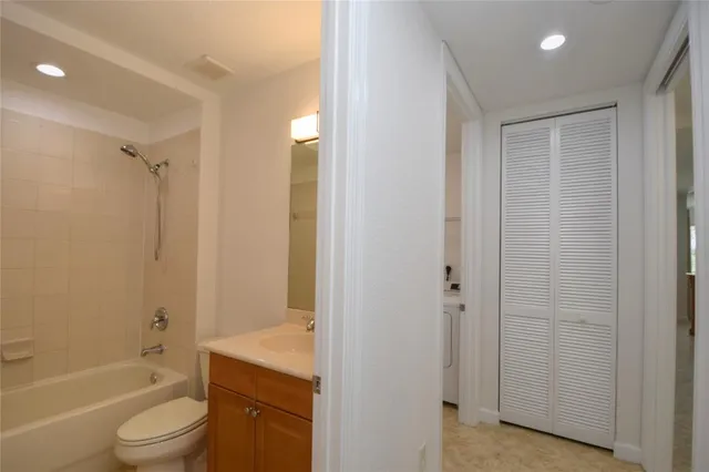 an empty room with wooden floor cabinet and windows