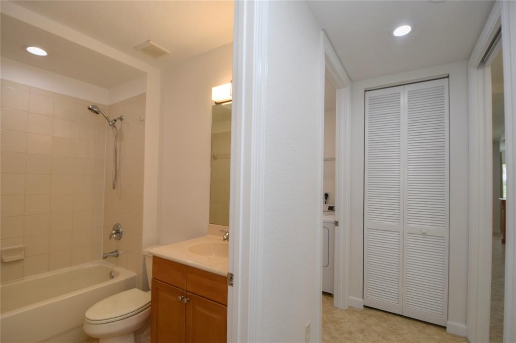 8297 Northwest 128th Lane, Unit 20C Parkland, FL 33076 - Photo 26 of 42 a bathroom with a granite countertop bathtub shower sink vanity and toilet