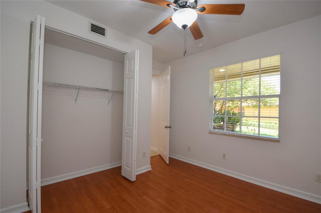 8297 Northwest 128th Lane, Unit 20C Parkland, FL 33076 - Photo 28 of 42 a view of an empty room with wooden floor and a window