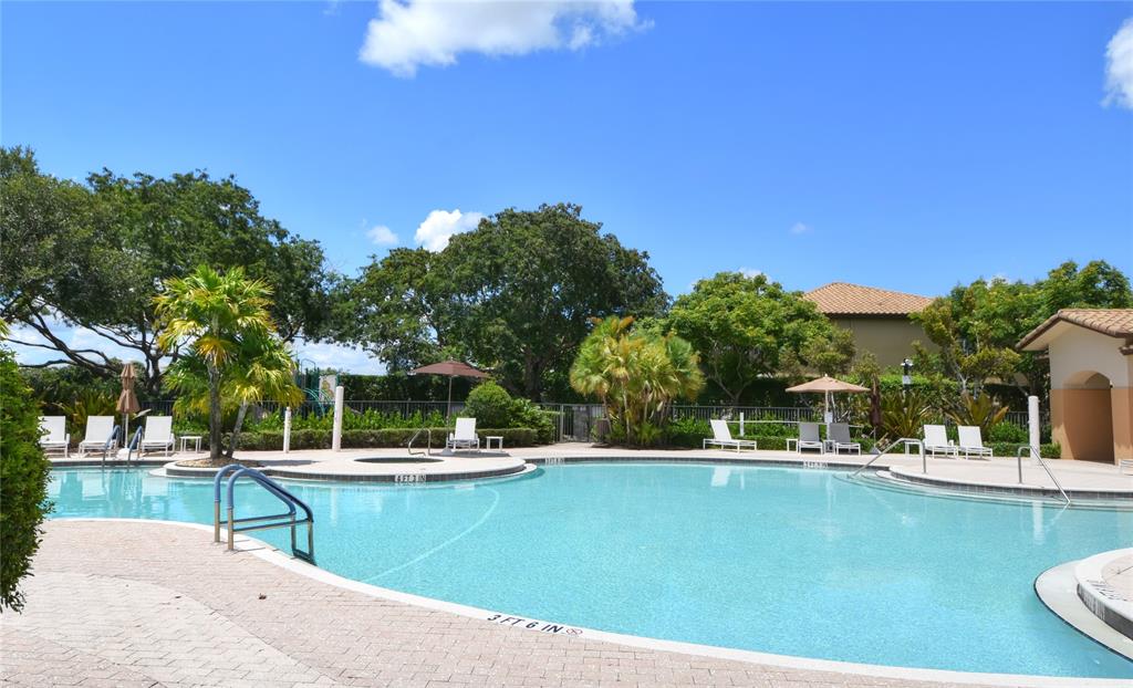 8297 Northwest 128th Lane, Unit 20C Parkland, FL 33076 - Photo 34 of 42 a view of a swimming pool with a patio