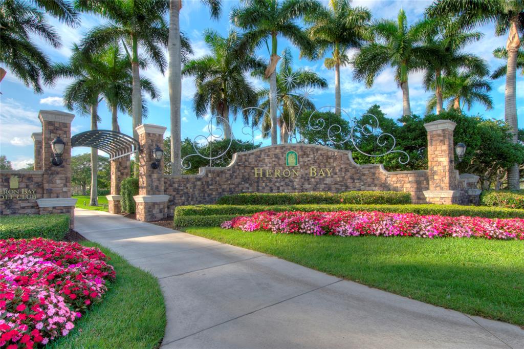 8297 Northwest 128th Lane, Unit 20C Parkland, FL 33076 - Photo 38 of 42 a view of yellow house with swimming pool and a yard