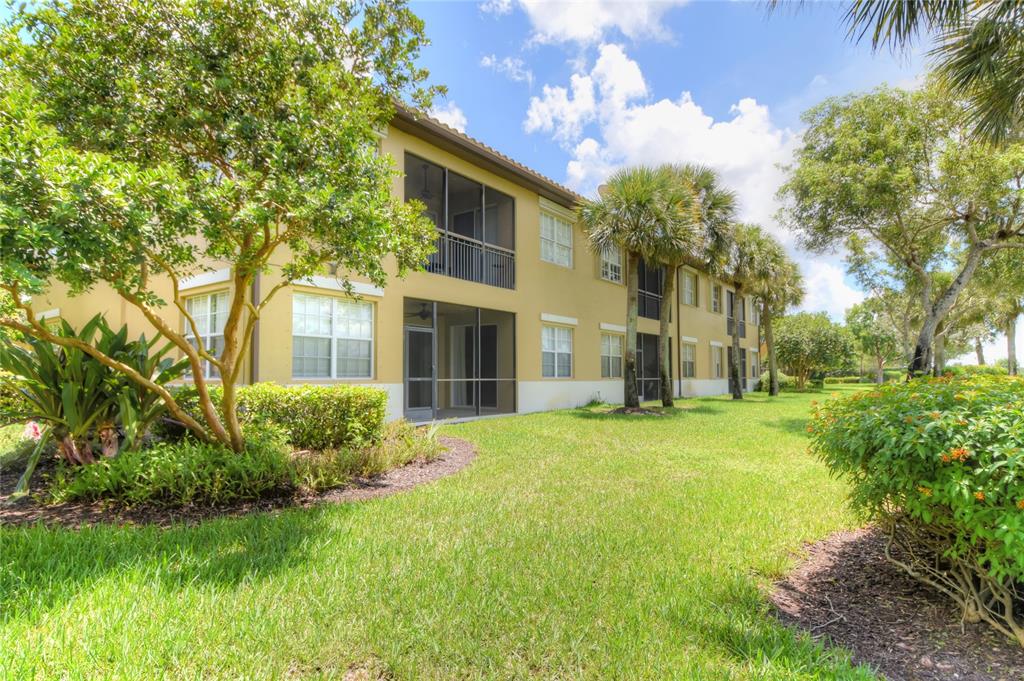 8297 Northwest 128th Lane, Unit 20C Parkland, FL 33076 - Photo 40 of 42 a front view of a house with garden