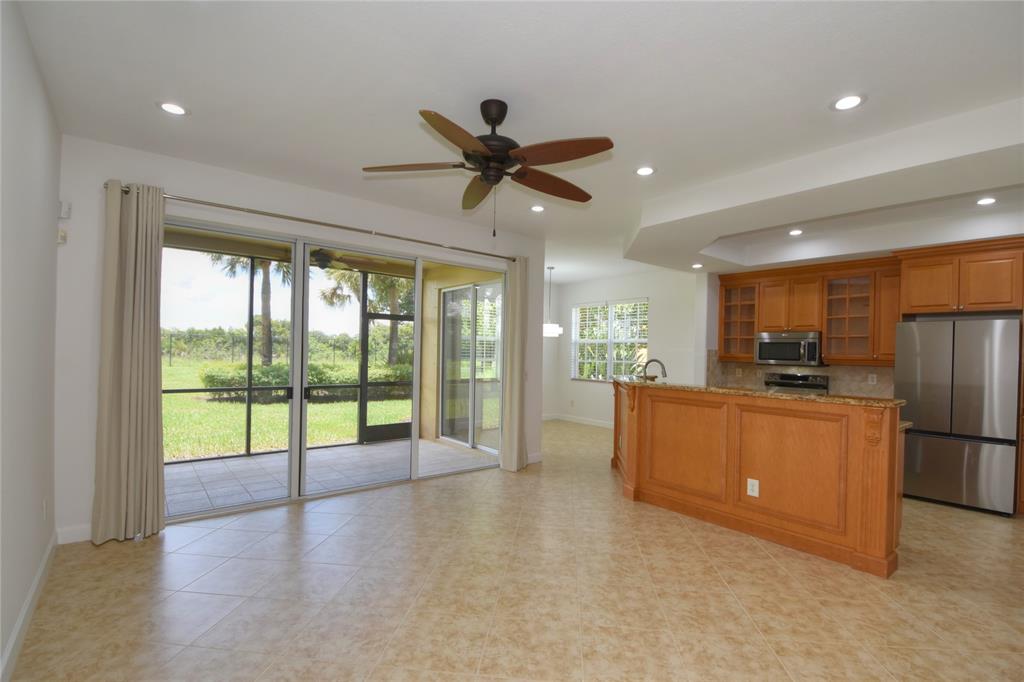 8297 Northwest 128th Lane, Unit 20C Parkland, FL 33076 - Photo 4 of 42 a open kitchen with stainless steel appliances granite countertop a refrigerator and a stove top oven