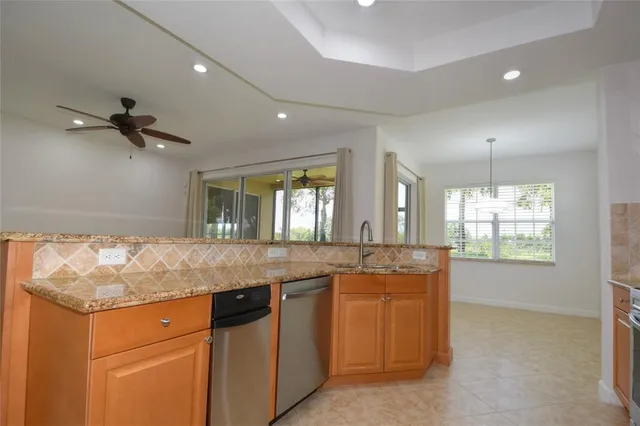 a living room with furniture and a ceiling fan