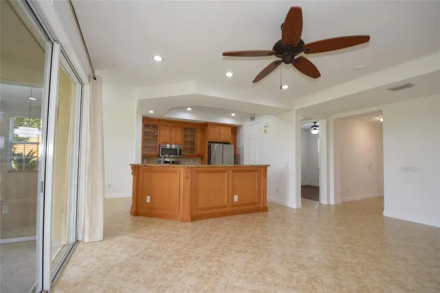 a living room with furniture and a ceiling fan