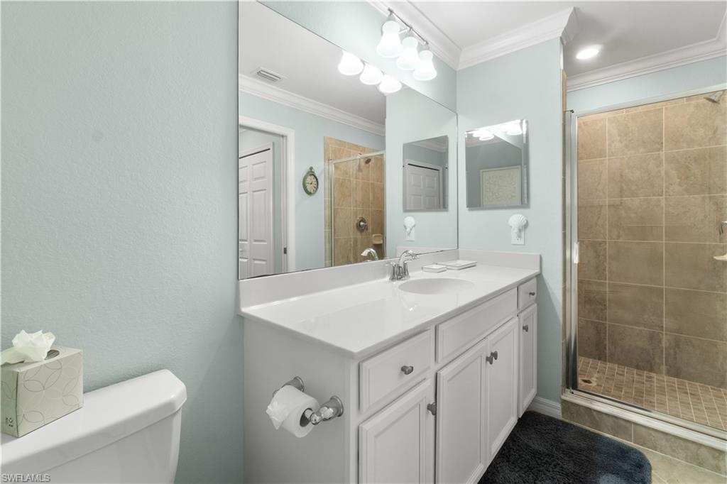 9578 Trevi Court, Unit 5135 Naples, FL 34113 - Photo 11 of 31 a bathroom with a sink a toilet and a mirror