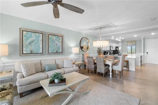 a living room with lots of furniture and view of kitchen