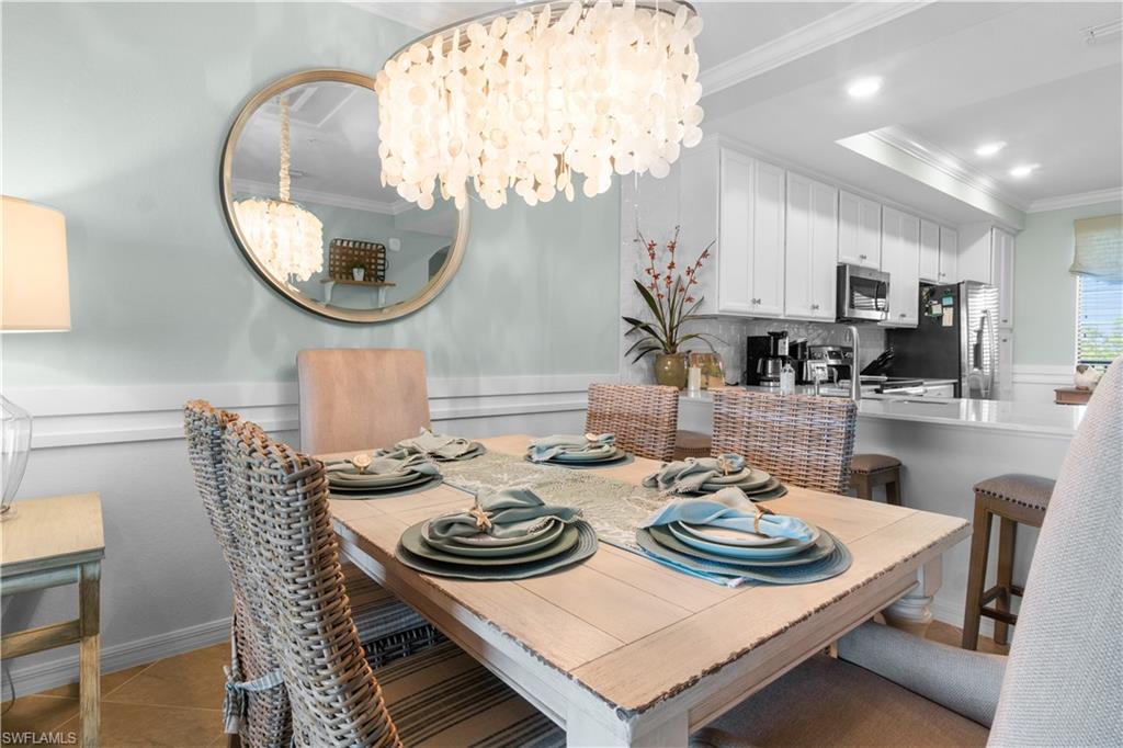 9578 Trevi Court, Unit 5135 Naples, FL 34113 - Photo 7 of 31 a dining room with furniture and a mirror