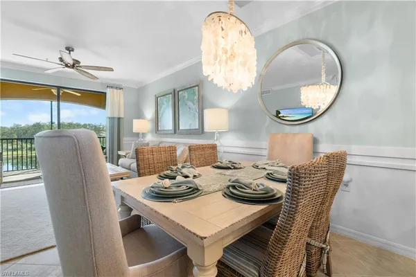 a view of a dining room with furniture and a chandelier