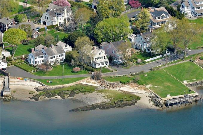 an aerial view of a house with a yard and lake
