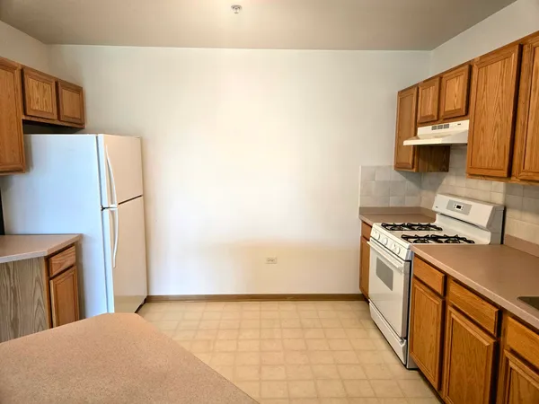 a kitchen with a stove a refrigerator and a sink