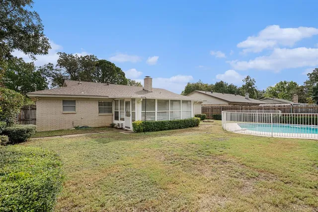 a view of a house with swimming pool and a yard