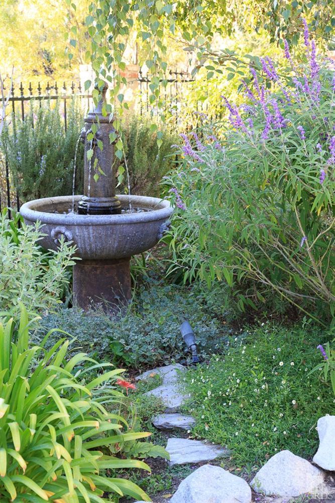 2748 Los Pinos Circle Camarillo, CA 93012 - Photo 29 of 37 a view of a backyard with plants and a fountain