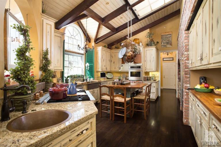 2748 Los Pinos Circle Camarillo, CA 93012 - Photo 9 of 37 a kitchen with a table chairs stove and cabinets