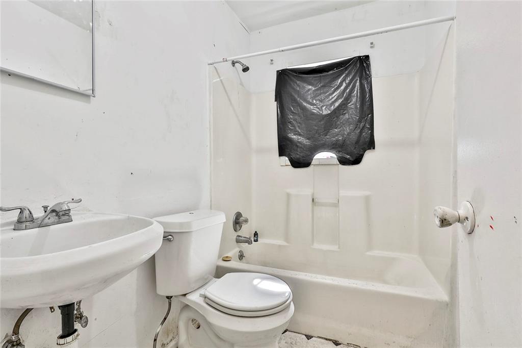 66 Howell Drive Southwest Atlanta, GA 30331 - Photo 14 of 27 a bathroom with a toilet and a sink