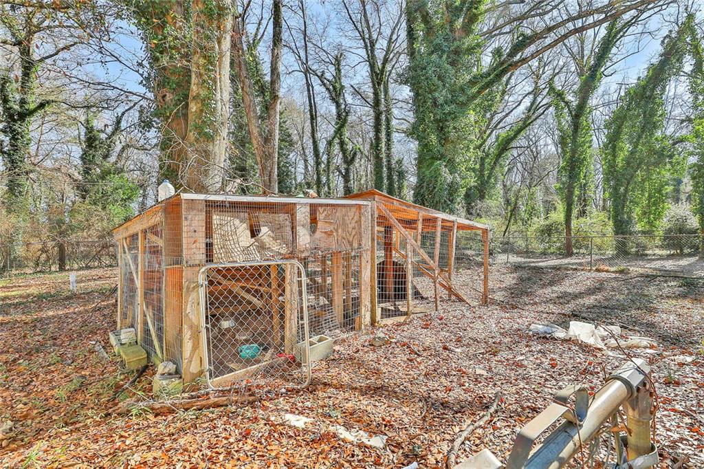 66 Howell Drive Southwest Atlanta, GA 30331 - Photo 22 of 27 a view of a blue house with trees in the background