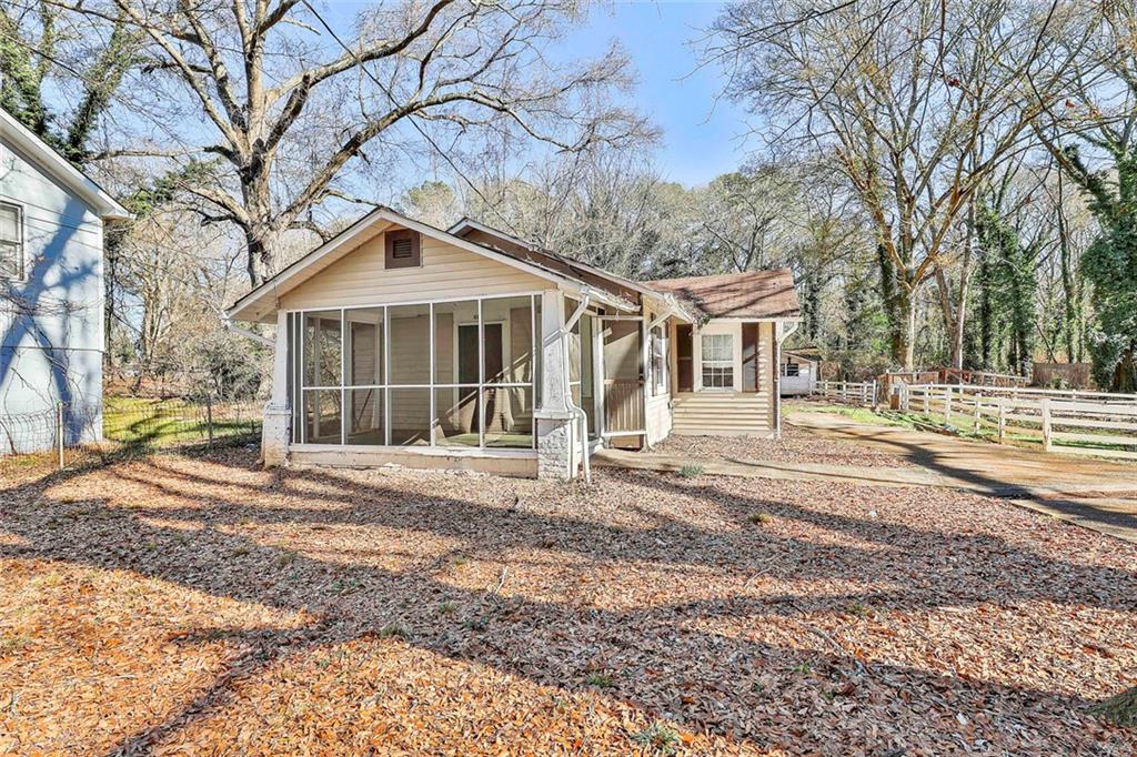 66 Howell Drive Southwest Atlanta, GA 30331 - Photo 4 of 27 a front view of a house with a garden and trees