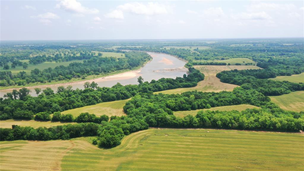 36980 Rd Arthur City Tx 75411 Road Arthur City, TX 75411 - Photo 16 of 23 a view of a lake with a yard