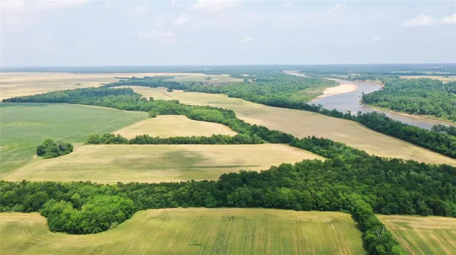 an aerial view of ocean with residential house and outdoor space