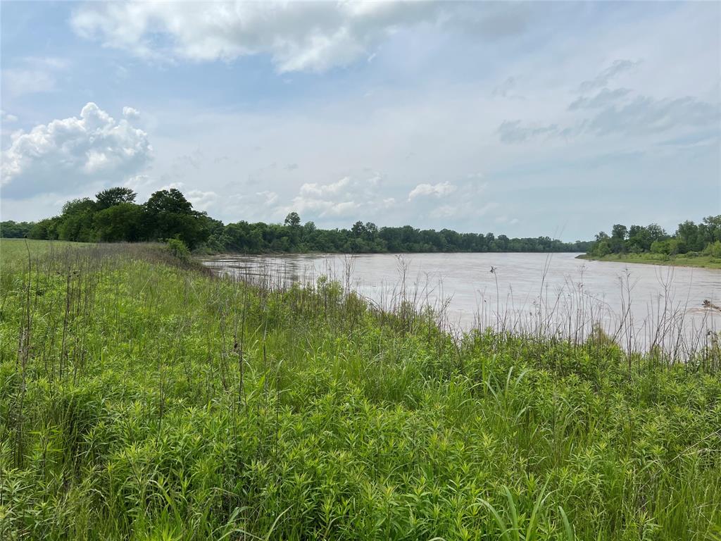 36980 Rd Arthur City Tx 75411 Road Arthur City, TX 75411 - Photo 2 of 23 a view of a lake with houses in the back