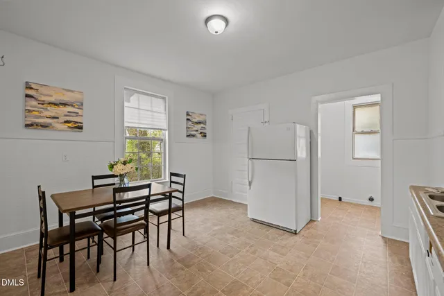 a view of a dining room with furniture and a window