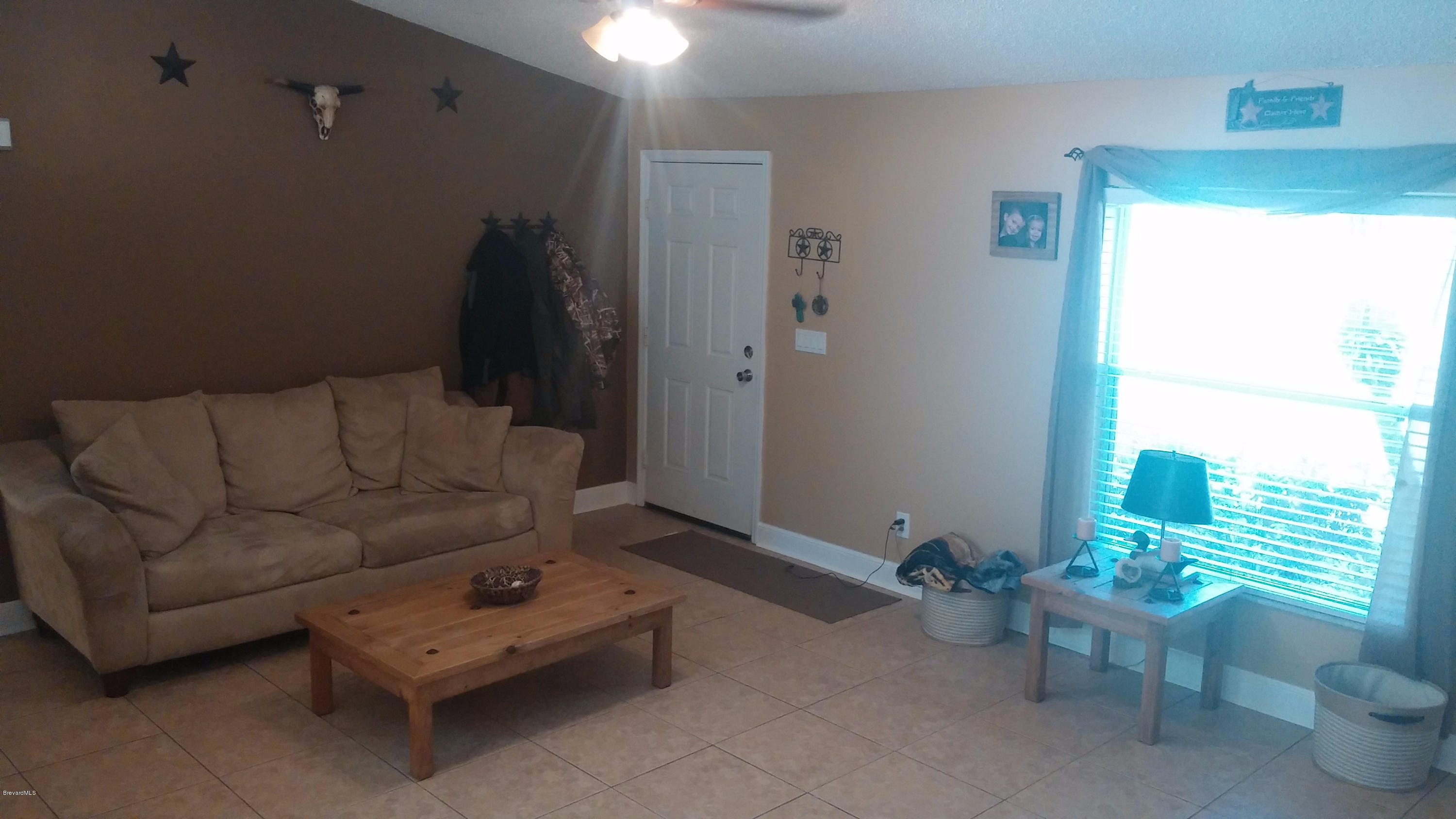 6950 Bryant Road Cocoa, FL 32927 - Photo 16 of 20 a living room with furniture and a window