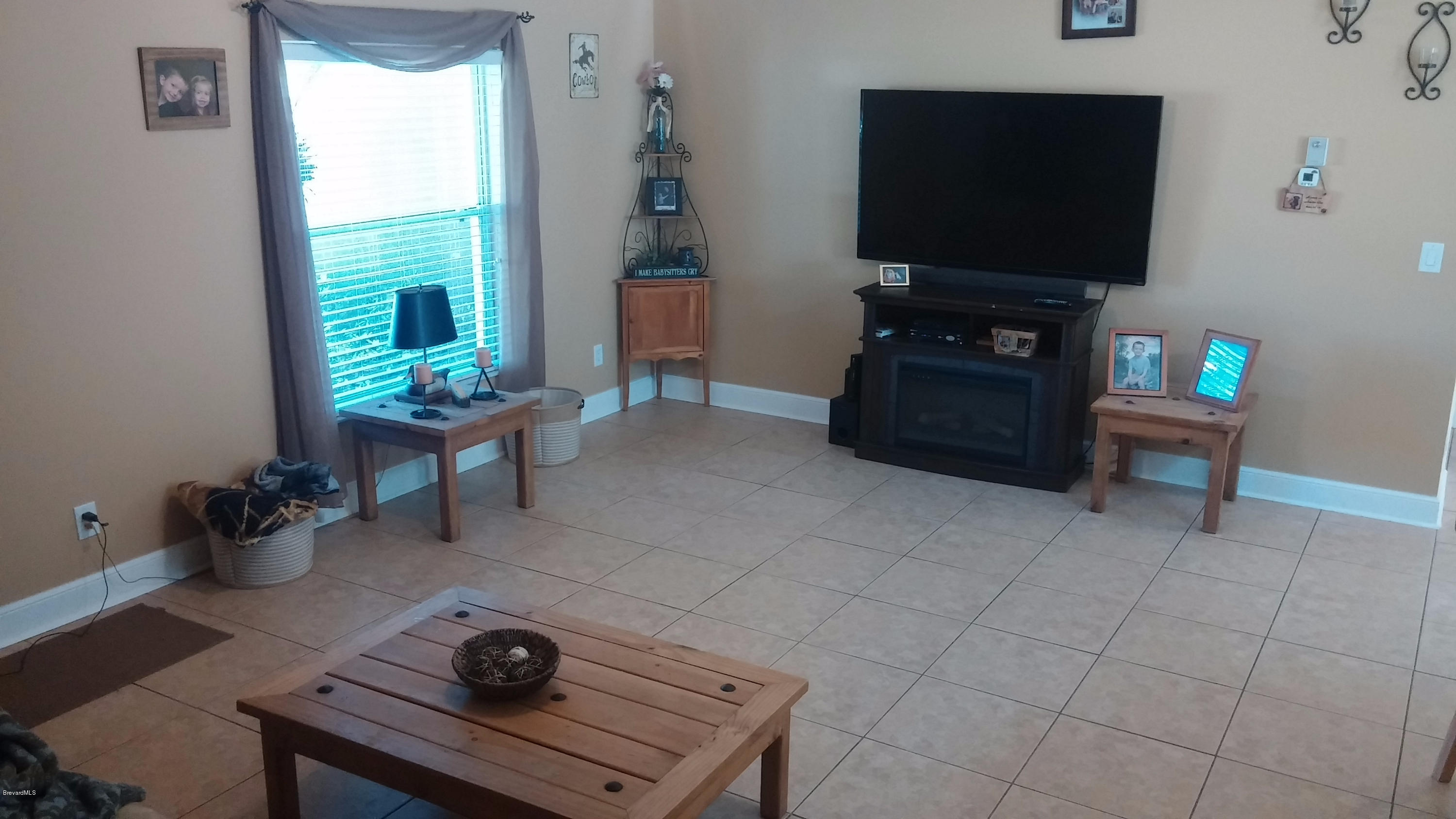 6950 Bryant Road Cocoa, FL 32927 - Photo 17 of 20 a living room with furniture and a flat screen tv