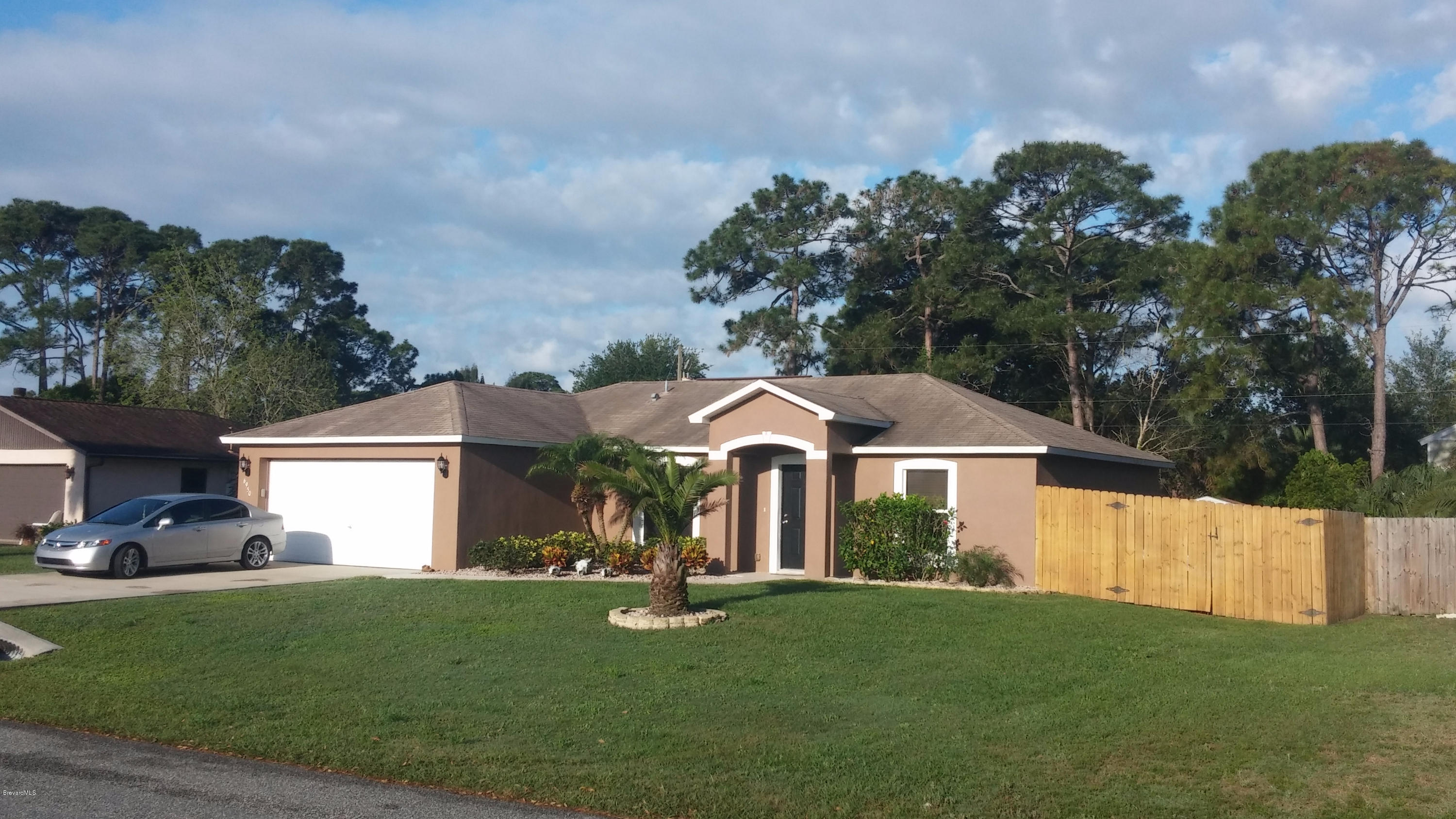 6950 Bryant Road Cocoa, FL 32927 - Photo 20 of 20 a front view of a house with a garden