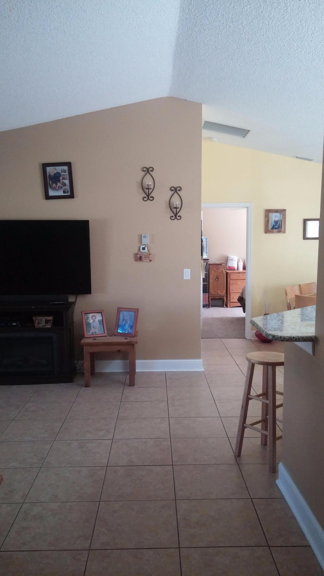 6950 Bryant Road Cocoa, FL 32927 - Photo 5 of 20 a living room with furniture and a flat screen tv
