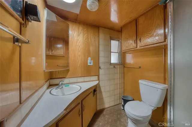 a bedroom with a bed and a refrigerator