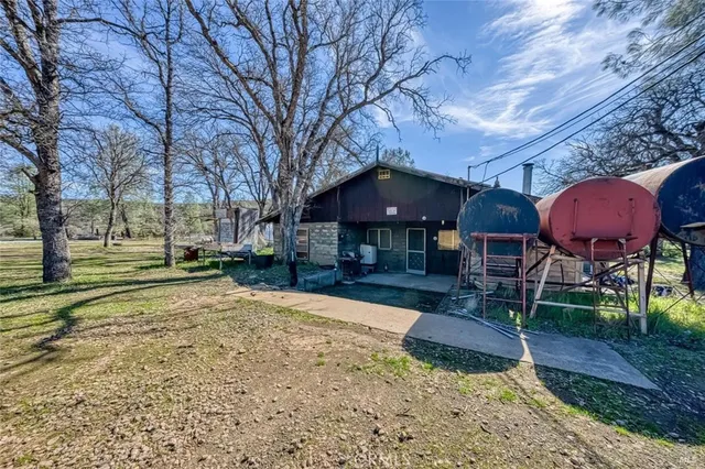a view of a house with backyard and sitting area