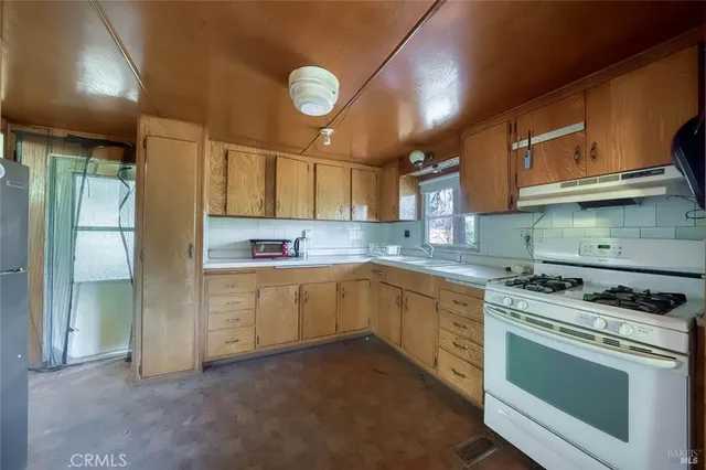 a kitchen with a sink cabinets and window