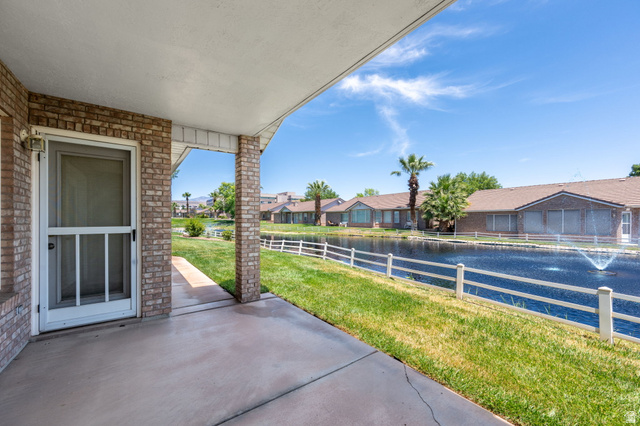 805 South River Road, Unit 70 St. George, UT 84790 - Photo 2 of 38 Covered patio with concrete flooring, brick columns, and a white screen door
