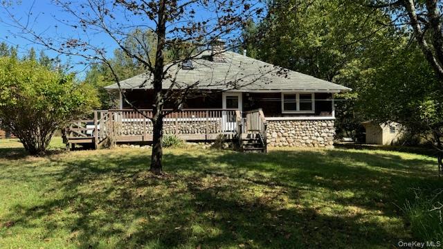 471 Mountain Road Bloomingburg, NY 12721 - Photo 1 of 1 Rear view of property featuring a shed, a wooden deck, and a yard