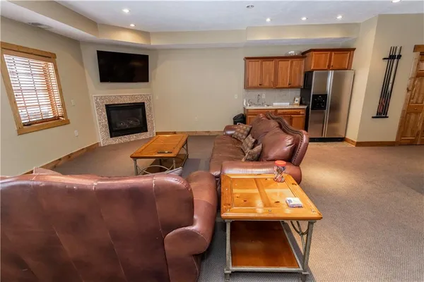 a living room with furniture a kitchen view and a kitchen view