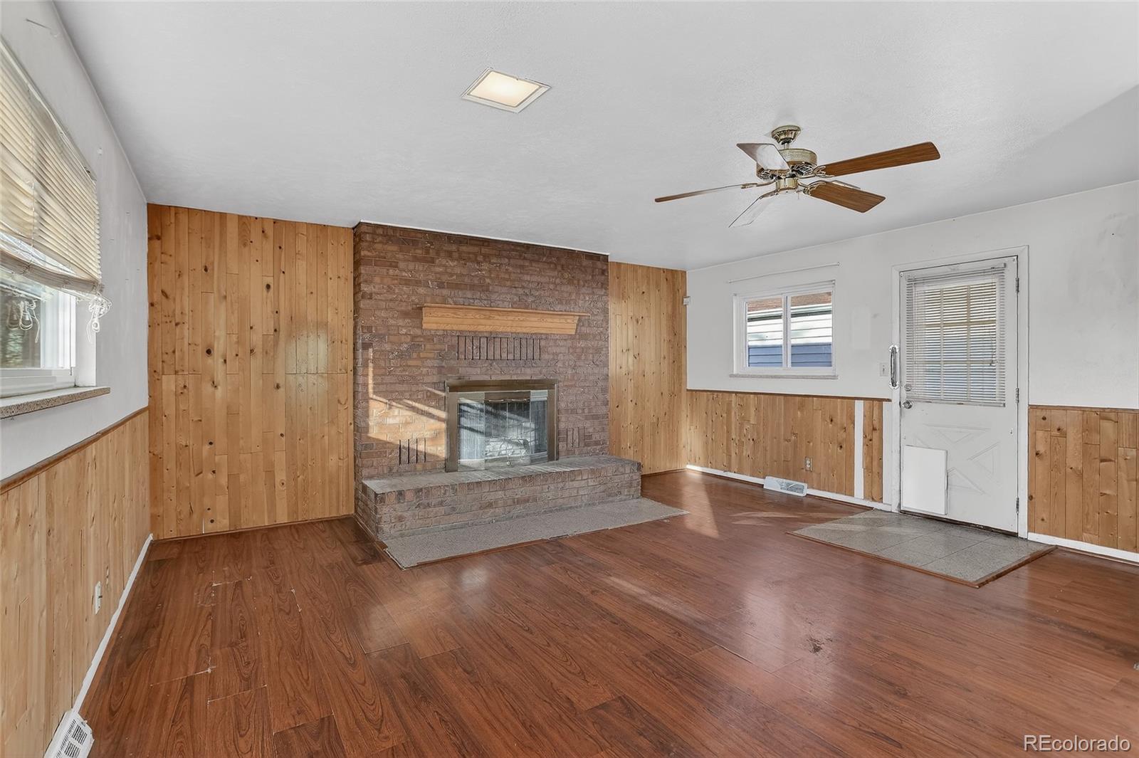 1279 South Raritan Street Denver, CO 80223 - Photo 13 of 21 a living room with wooden floor and a fireplace