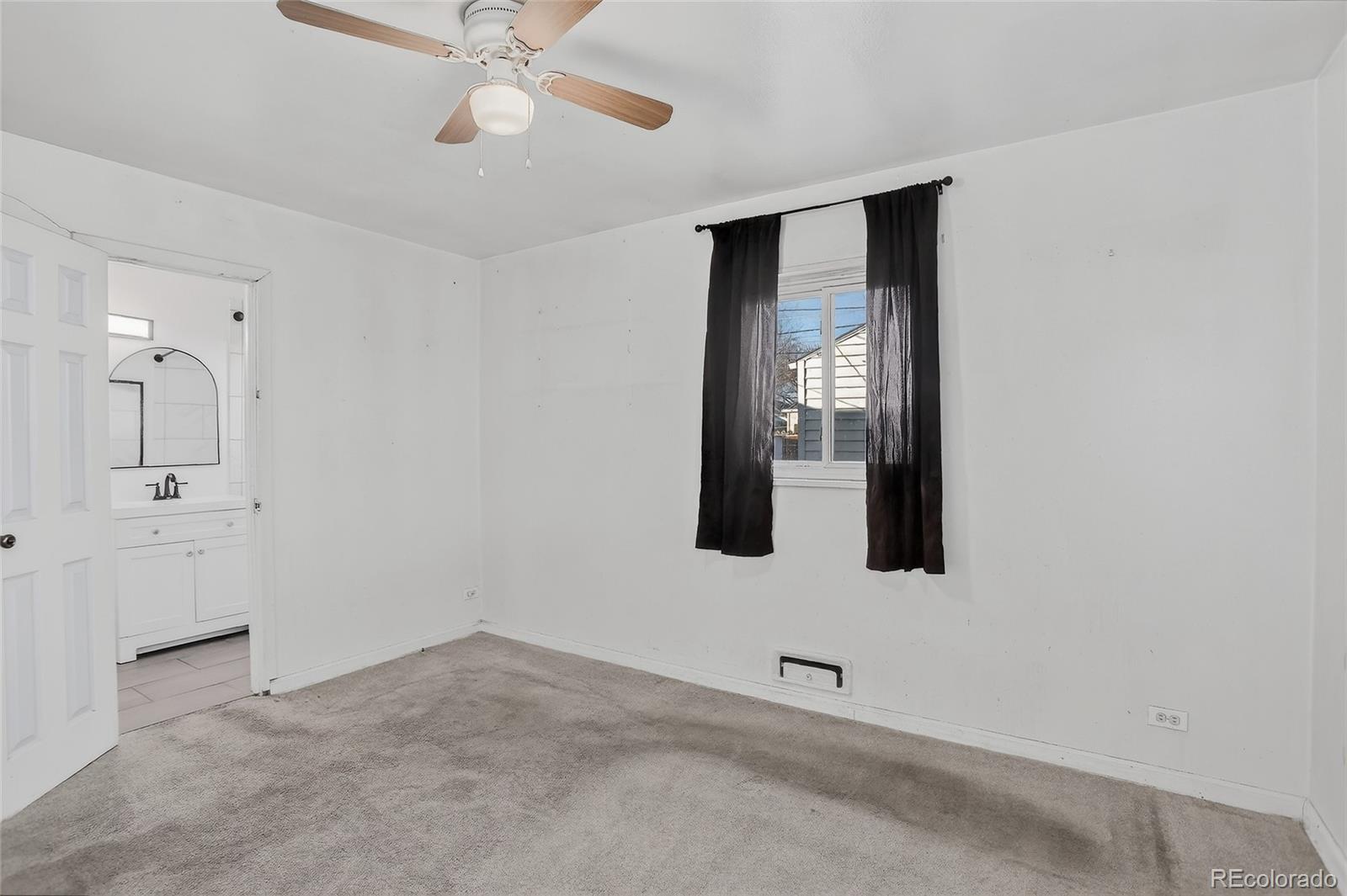 1279 South Raritan Street Denver, CO 80223 - Photo 14 of 21 an empty room with mirror and fan