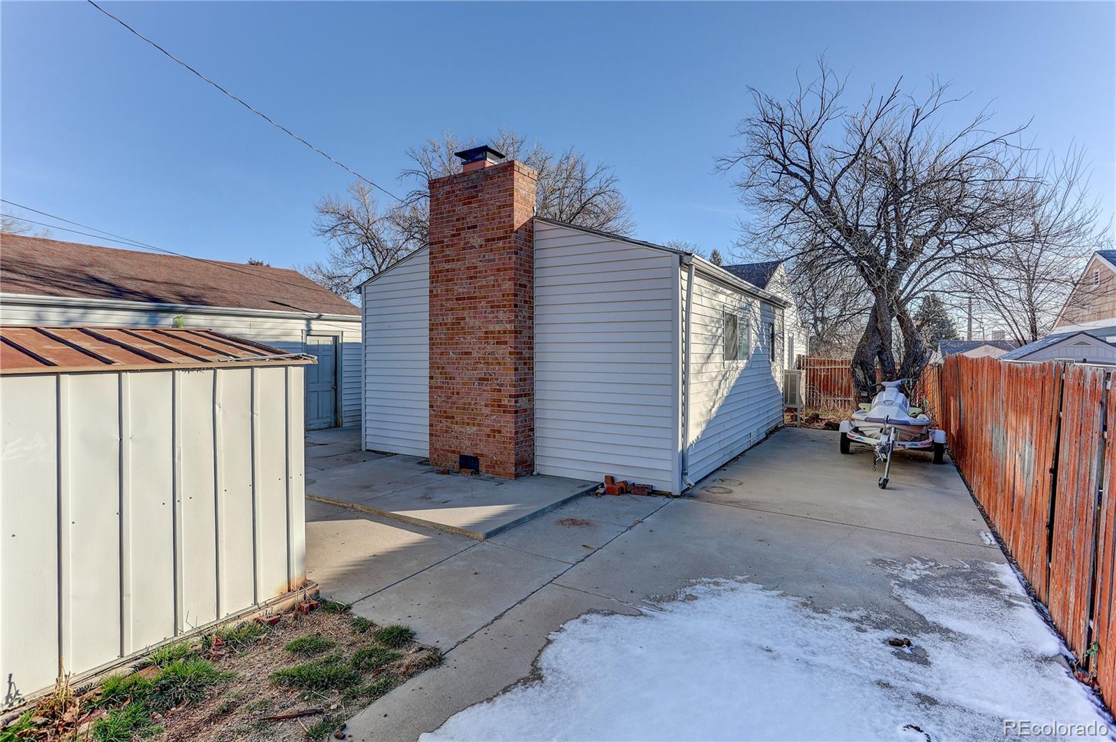 1279 South Raritan Street Denver, CO 80223 - Photo 2 of 21 a view of a house with wooden fence