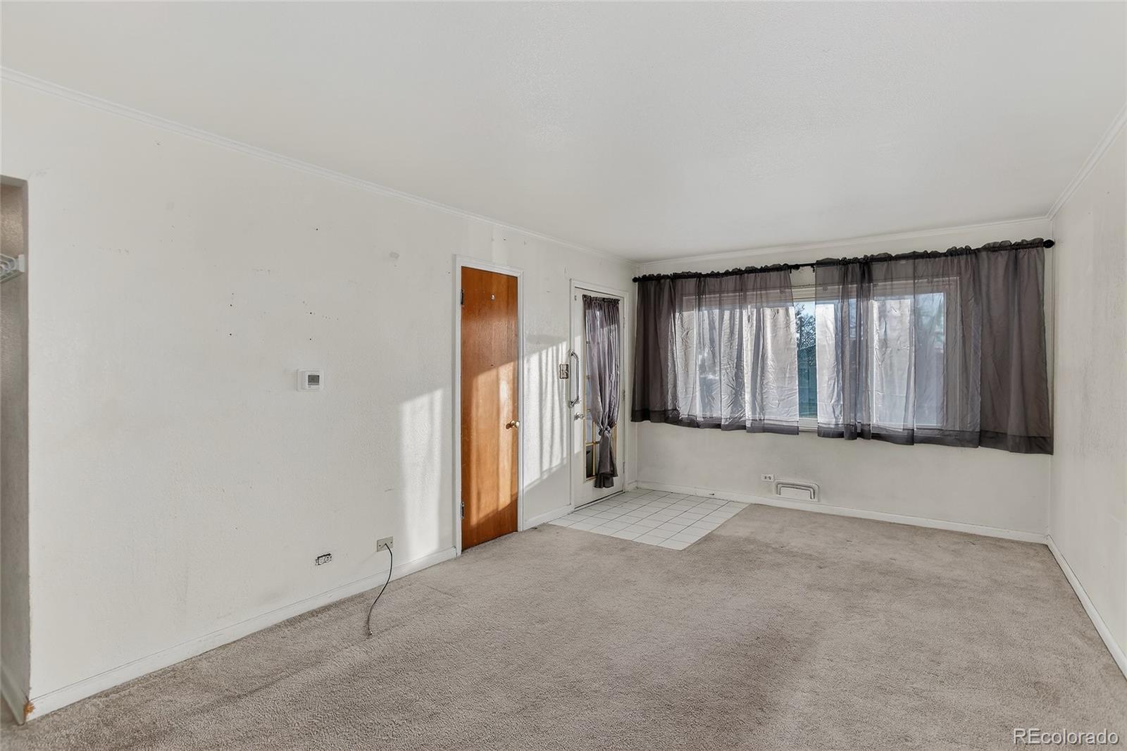 1279 South Raritan Street Denver, CO 80223 - Photo 6 of 21 a view of an empty room with a window