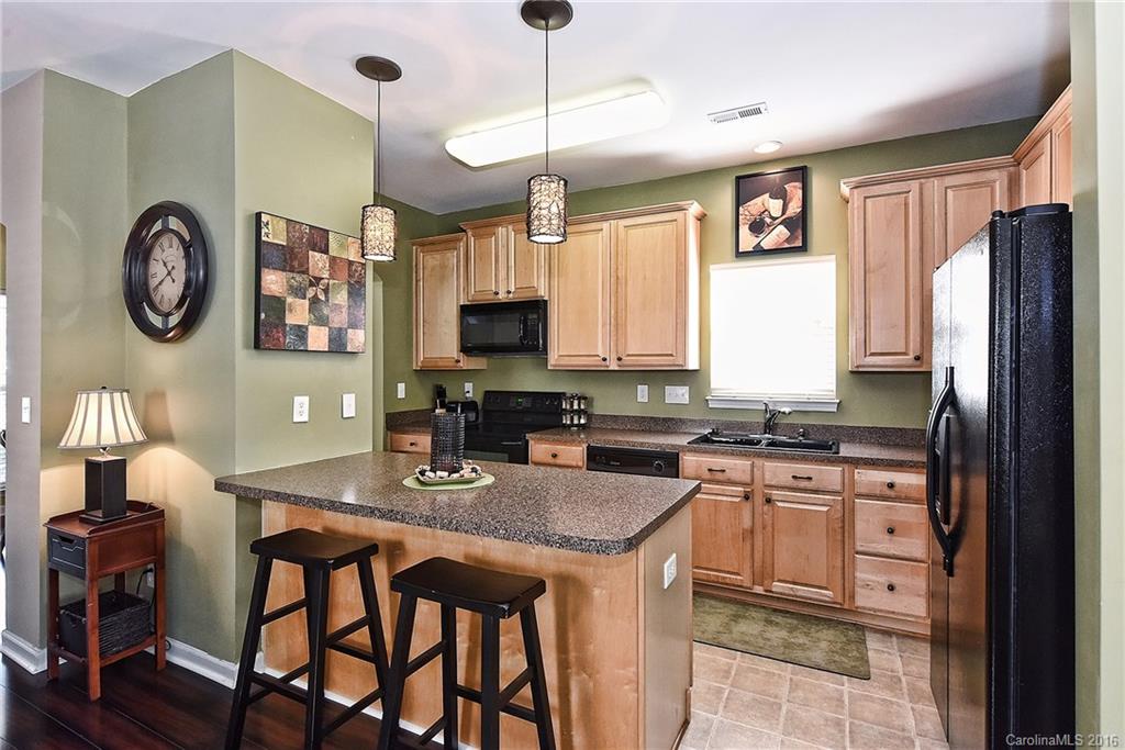 8905 Washam Potts Road Cornelius, NC 28031 - Photo 14 of 24 a kitchen with stainless steel appliances granite countertop a stove top oven a refrigerator a sink and a stove
