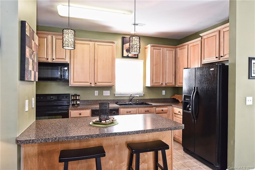 8905 Washam Potts Road Cornelius, NC 28031 - Photo 15 of 24 a kitchen with stainless steel appliances granite countertop a refrigerator a sink a stove and cabinets
