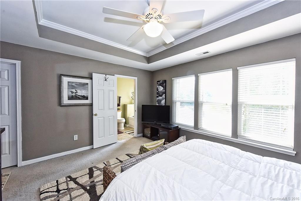 8905 Washam Potts Road Cornelius, NC 28031 - Photo 20 of 24 a bedroom with a bed and a large window