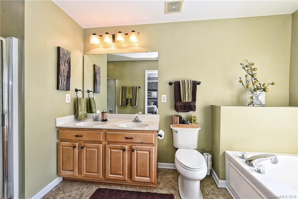 8905 Washam Potts Road Cornelius, NC 28031 - Photo 21 of 24 a bathroom with a toilet sink and mirror