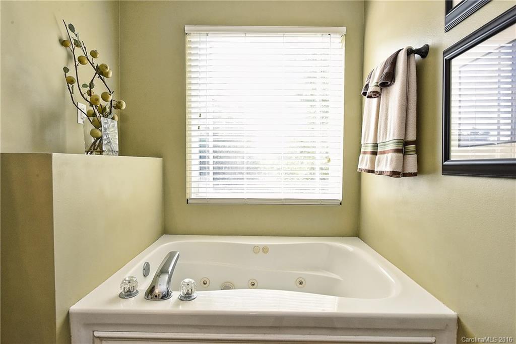 8905 Washam Potts Road Cornelius, NC 28031 - Photo 22 of 24 a bathroom with a bathtub and a window