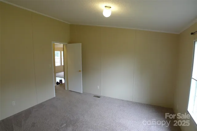 a view of a livingroom with a ceiling fan and window