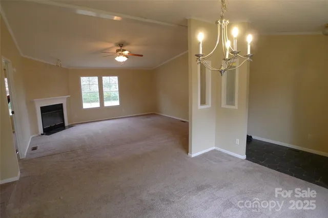 a view of a livingroom with a chandelier fan