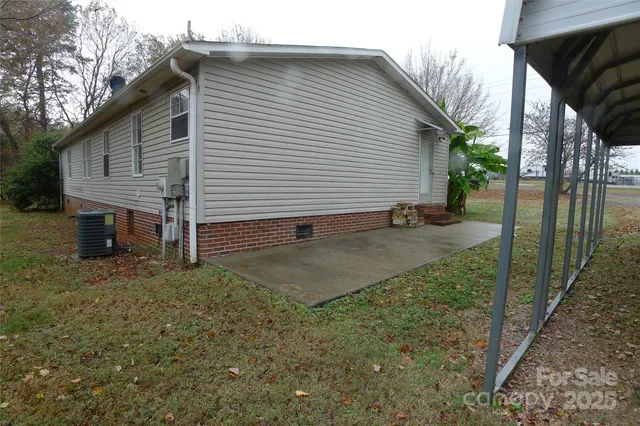 a view of a house with backyard and trees