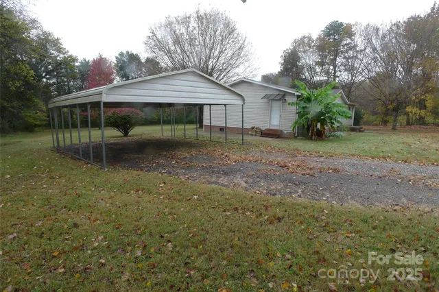 a backyard of a house with wooden fence and porch